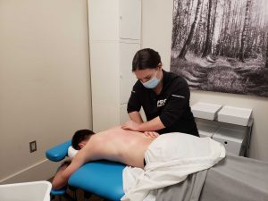 Registered Massage Therapist Stephanie Van Erp Massaging a patients low back