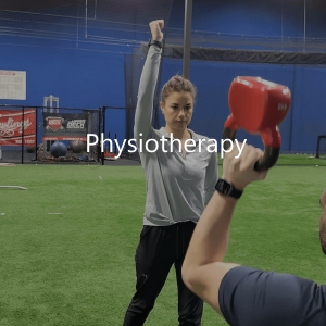 Woman training a male patient is physiotherapy using a red kettle bell